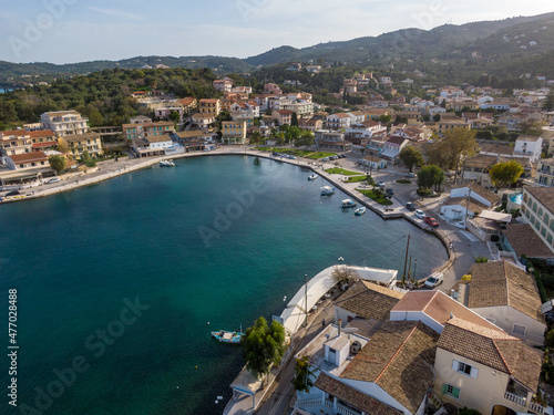 Fototapeta Naklejka Na Ścianę i Meble -  Aerial drone view over Kassiopi marina, iconic small port and fishing village at North of Island of Corfu, Greece.