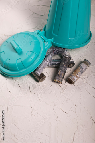 Corroded waste batteries. Finger-type batteries and accumulators for disposal. They lie in a trash can. Recycling of hazardous waste.