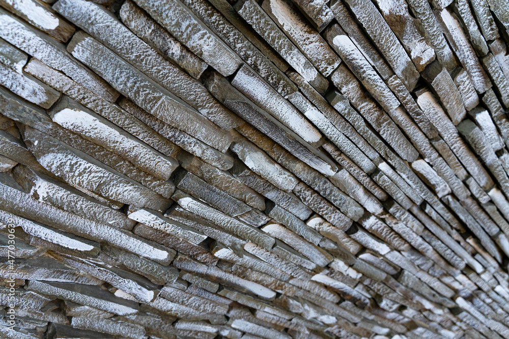 Horizontal photo of a stone wall with a diagonal decorative facade