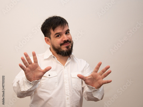 Young man with beard showing the palm of his hands