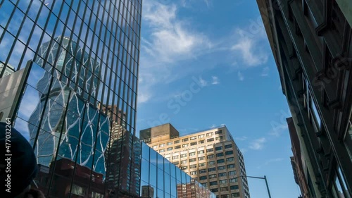 Time Lapse of Clouds Moving with Blue Skies Reflected on Glass Buildings