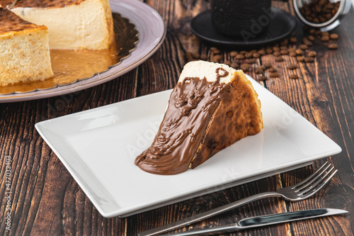 San Sebastian Cheesecake with Chocolate Poured on it photo
