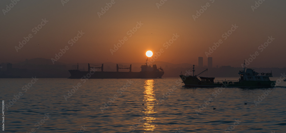 sunrise over the Bosphorus Strait with views from the European side towards Asia. boats under the sunrise sun.