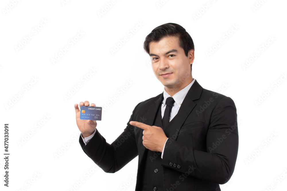 Handsome business man in black suit holding and finger pointing to credit card isolated on white background. Business, technology, ecommerce and online payment concept. Handsome business man in black suit holding and finger pointing to credit card isolated on white background. Business, technology, ecommerce and online payment concept.