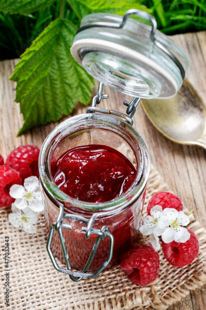 Bowl of raspberry jam on a wooden table. Bowl of raspberry jam on a wooden table.