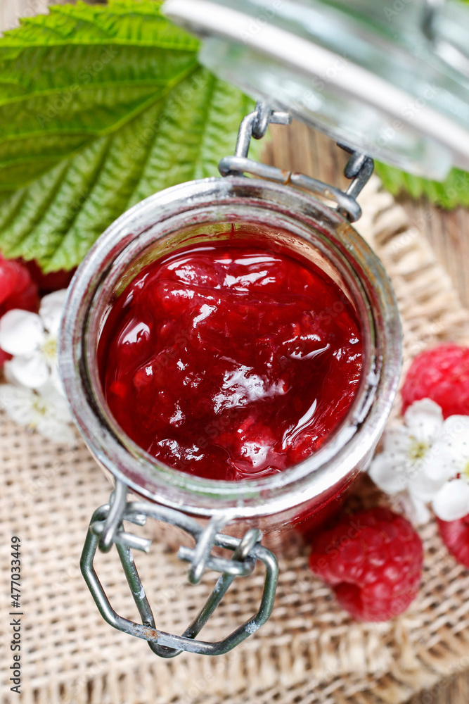 Bowl of raspberry jam on a wooden table. Bowl of raspberry jam on a wooden table.