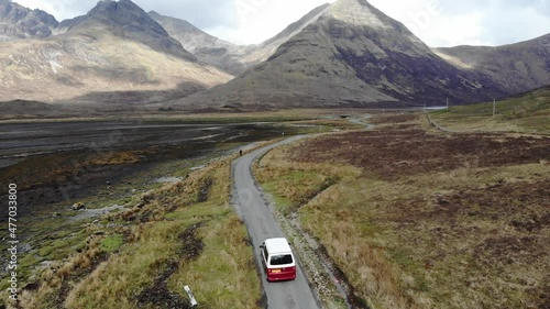 A panning aerial shot in the wilderness with a VW campervan, in the far outreaches of the Scottish Highlands towards the Isle of Skye in Scotland.  photo