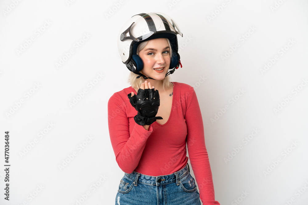Young caucasian woman with a motorcycle helmet isolated on white background inviting to come with hand. Happy that you came Young caucasian woman with a motorcycle helmet isolated on white background inviting to come with hand. Happy that you came