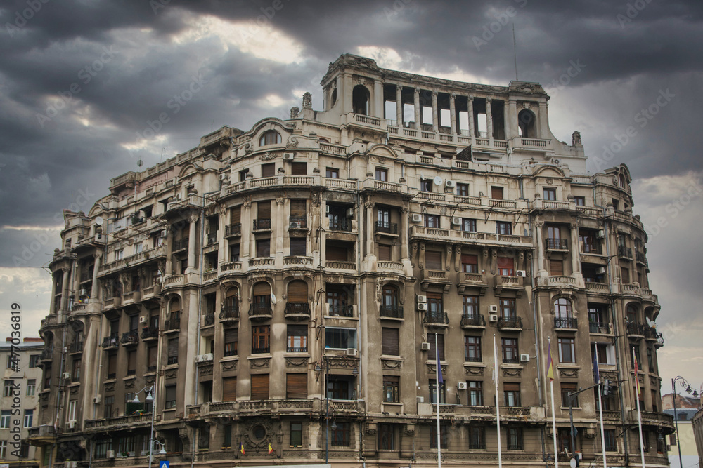 Exterior of apartment buildings with balconies with dramatic sky. Old Buildings In Bucharest. Travel Romania