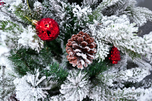 Christmas tree decoration with toys and cone close up