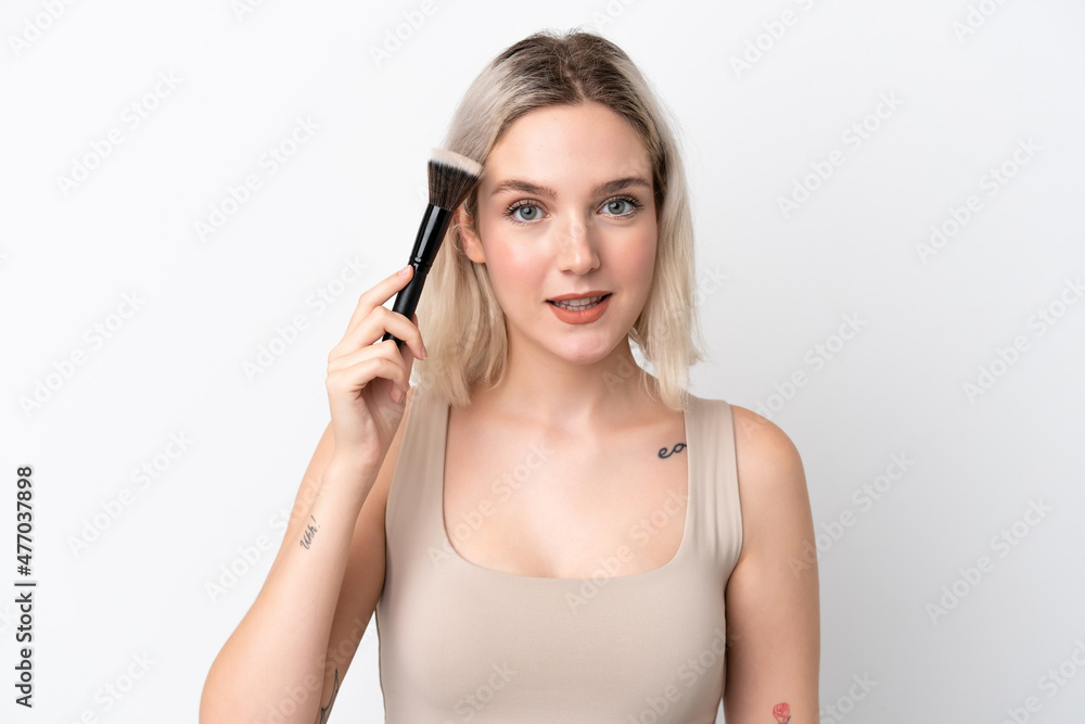 Young caucasian woman isolated on white background holding makeup brush Young caucasian woman isolated on white background holding makeup brush