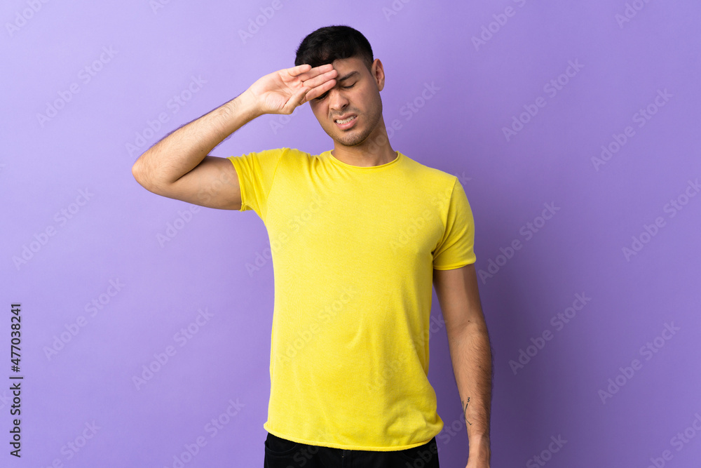 Young Colombian man isolated on purple background with tired and sick expression Young Colombian man isolated on purple background with tired and sick expression