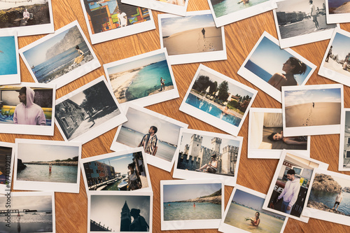 Beautiful holiday collage made of many photos. Printed pictures of holidays. Printed photos on wooden background © Yon