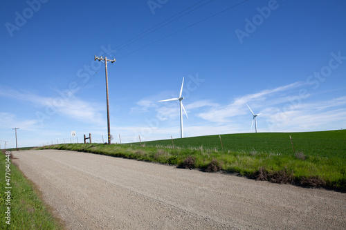 Wind turbines with blue sky and country road