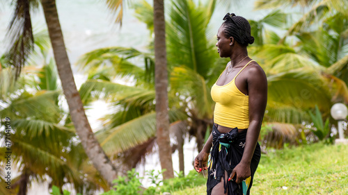 African woman from Ghana stands with summer dress by the sea in Axim Ghana.