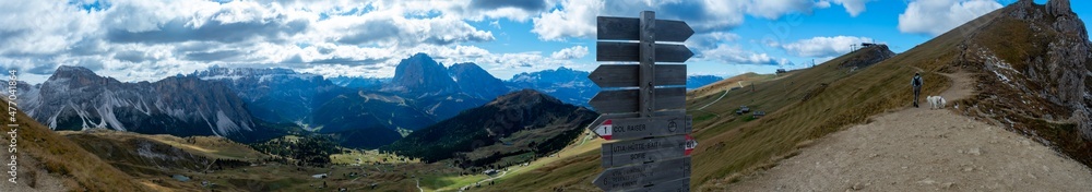 Trail Marker Signs with dramatic mountain background. Hiking Dolomites in European Alps. Gardena Pass, Italy