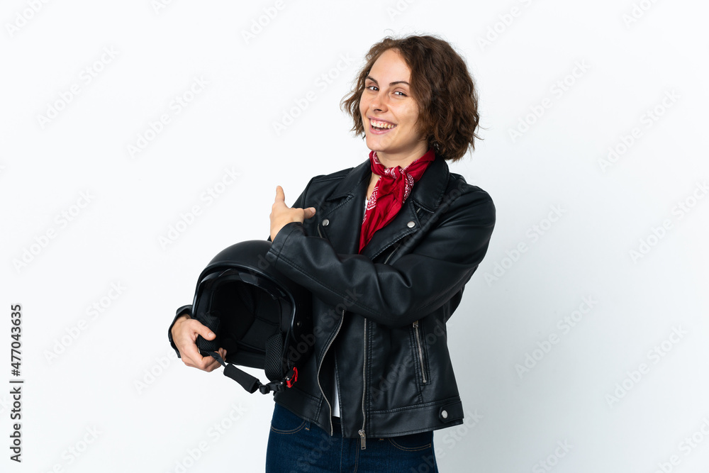 English woman holding a motorcycle helmet isolated on white background pointing back English woman holding a motorcycle helmet isolated on white background pointing back