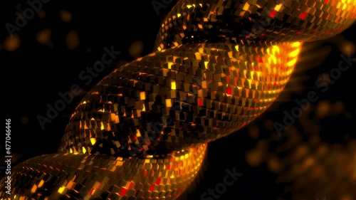 Gold and black abstract background with metal rope looking like snake scales. Twisting metal shain on shimmering background, seamless loop. photo