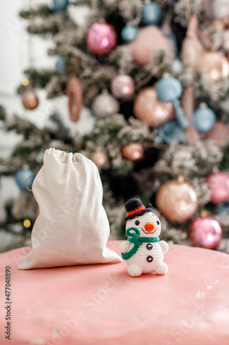 Knitted toy hanging on a christmas tree