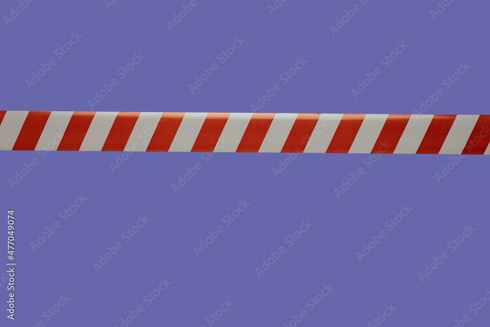 Red and white tape is used for fencing on a purple background.barrier tape against penetration Red and white tape is used for fencing on a purple background.barrier tape against penetration