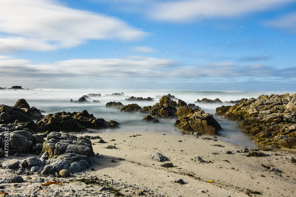 Long exposure photography of Pacific Ocean waves against rocky coast of California Long exposure photography of Pacific Ocean waves against rocky coast of California