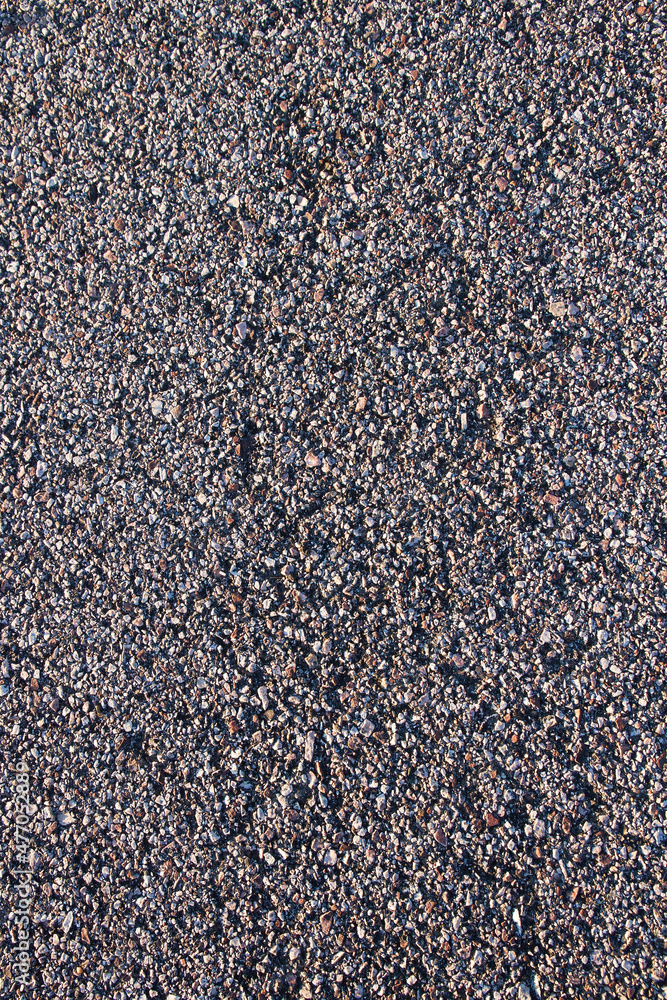 Texture in detail of old asphalt road with gravel or pebbles Texture in detail of old asphalt road with gravel or pebbles