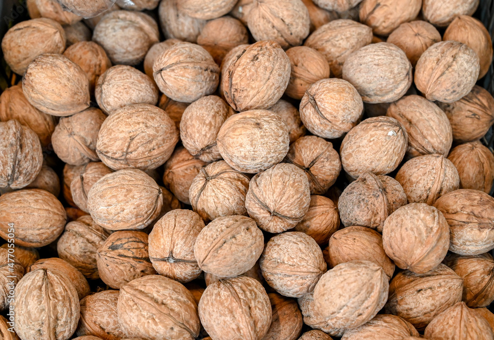 Walnuts for sale in market. Close up of walnuts in shells in supermarket. Dried fruit for sale on Bazaar. Walnuts for sale in market. Close up of walnuts in shells in supermarket. Dried fruit for sale on Bazaar.