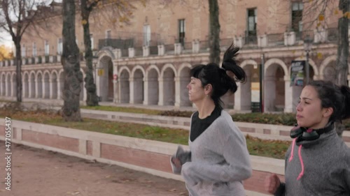 Latin and Spanish Friends jogging in Aranjuez, Madrid during winter. slow motion run exercise 4k