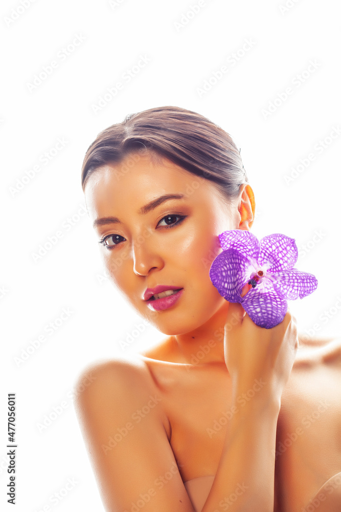 young pretty asian woman with flower purple orchid isolated on white background, spa people concept young pretty asian woman with flower purple orchid isolated on white background, spa people concept