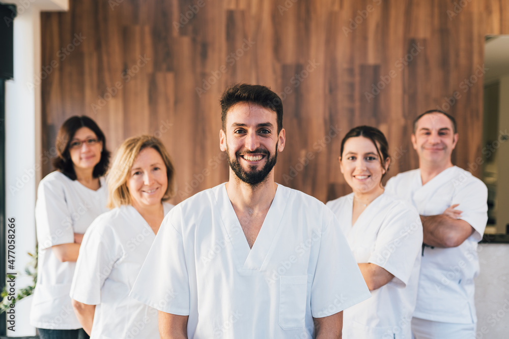 Chiropodists team doctors looking at camera and smiling in medical center with white medical gown. Chiropodists team doctors looking at camera and smiling in medical center with white medical gown.
