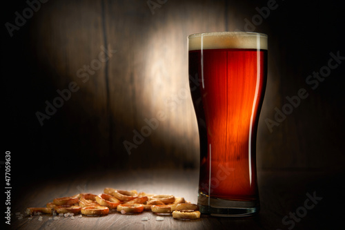 Beer and pretzels with salt on a wooden background.