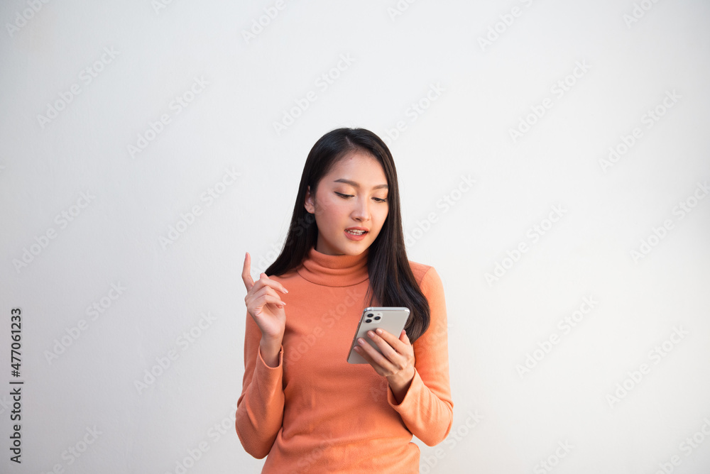 Attractive teenage girl poses to use the smartphone to communicate for use in advertising media Attractive teenage girl poses to use the smartphone to communicate for use in advertising media