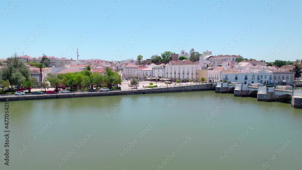 Aerial view of Tavira, Portugal, Algarve coast by Ria Formosa Natural Park. A Portuguese town with Medieval Castle, Santa María do Castelo Church and Ponte Romana de Tavira by the Gilão River in 4K. Aerial view of Tavira, Portugal, Algarve coast by Ria Formosa Natural Park. A Portuguese town with Medieval Castle, Santa María do Castelo Church and Ponte Romana de Tavira by the Gilão River in 4K.