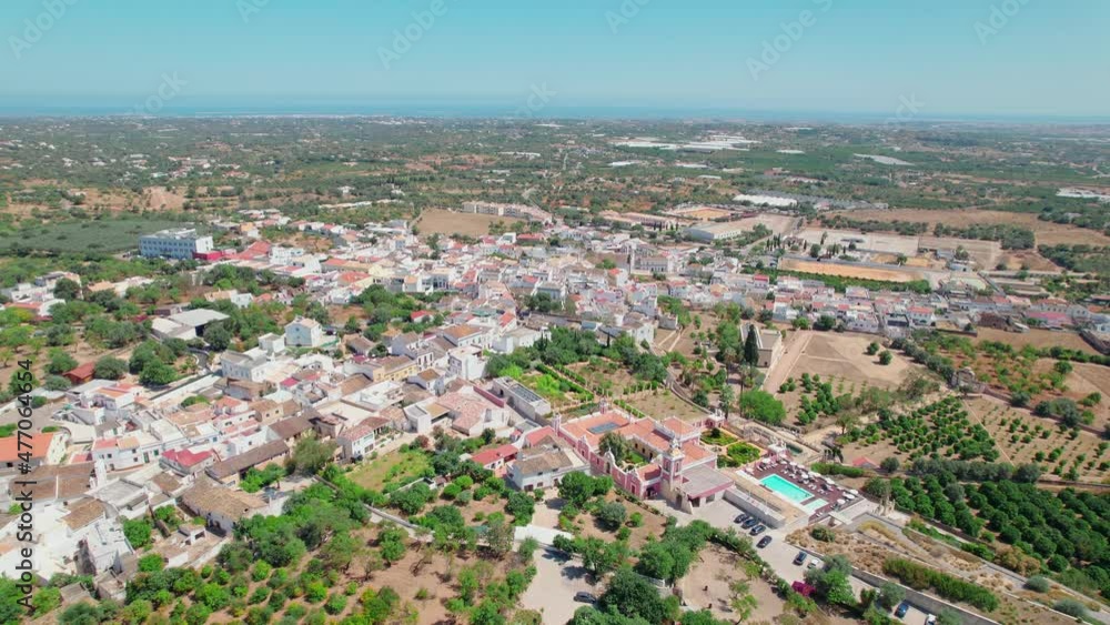Portuguese historical village on a sunny day with traditional houses from above. Roman Ruins of Milreu and Estoi Palace / Pousada Palácio Estói Resort Hotel with pool in 4K. Portuguese historical village on a sunny day with traditional houses from above. Roman Ruins of Milreu and Estoi Palace / Pousada Palácio Estói Resort Hotel with pool in 4K.