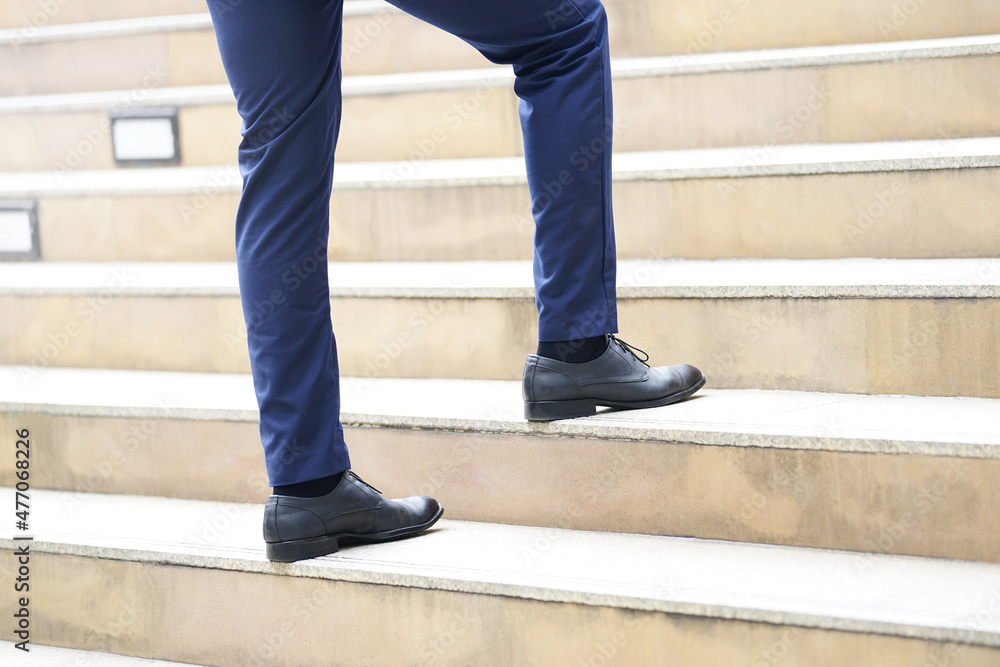 Business man's legs walking up stairs Business man's legs walking up stairs
