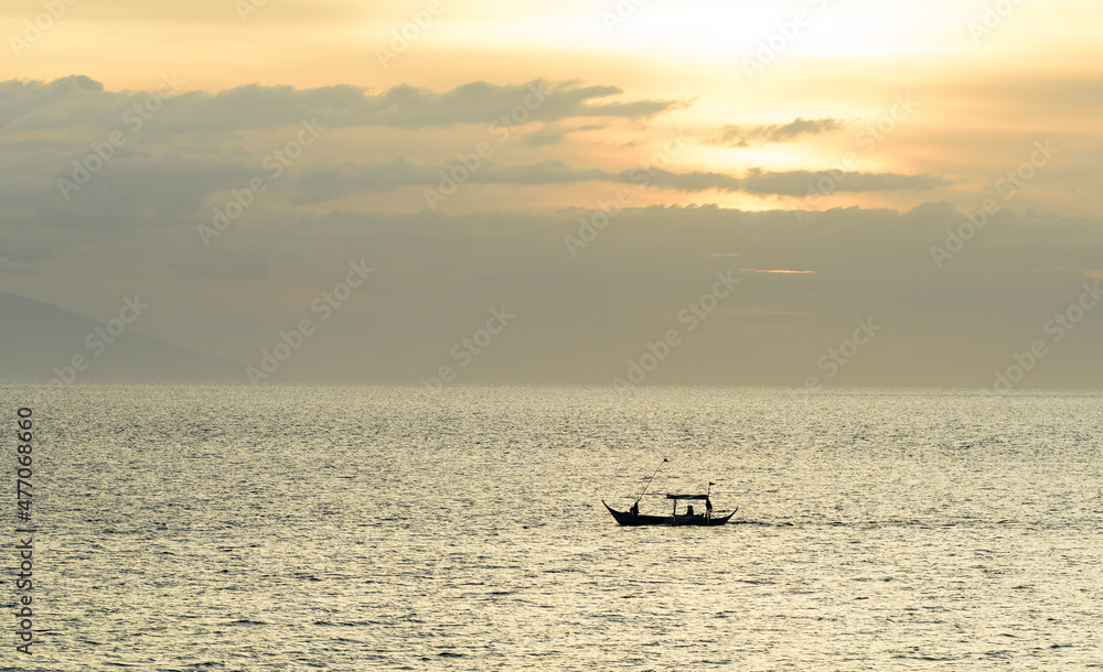 A gorgeous sunset over the Pacific Ocean with silhouette shots of fishing boats. 