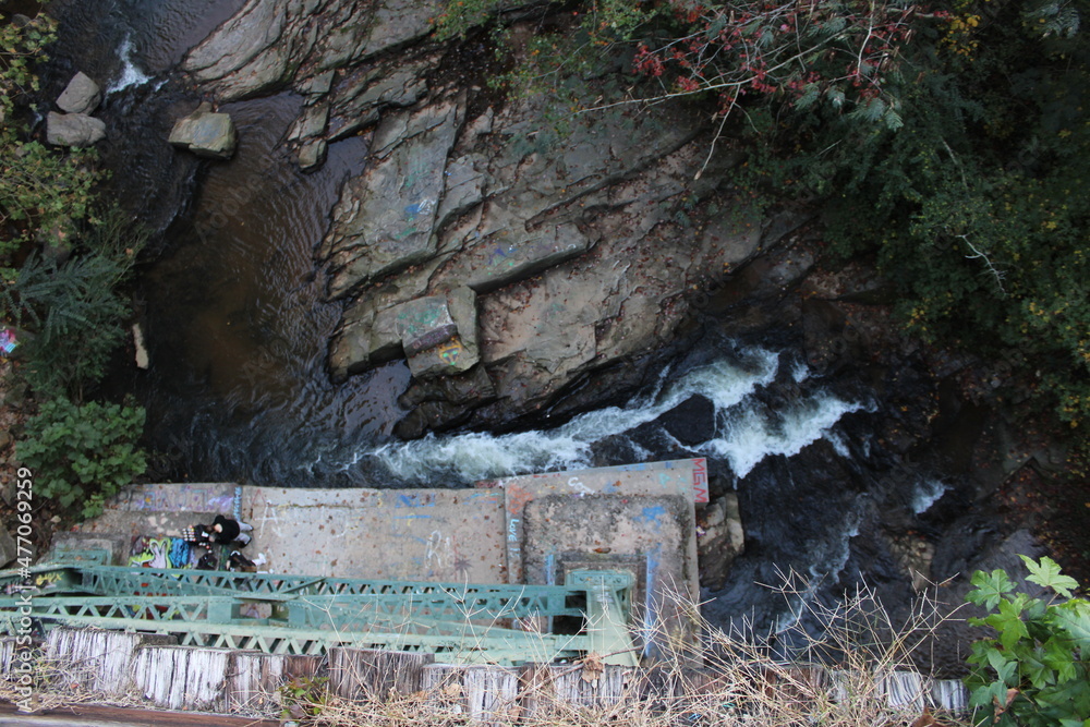 Fototapeta premium Amazing Ariel river picture with rocks over a bridge at the Silver Comet Trail in Georgia.