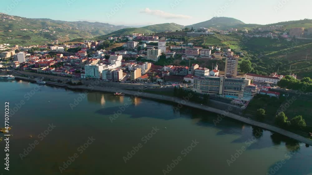 Aerial view of Peso da Régua, Vila Real District along the Douro Valley River. Traditional tourist destination in Portugal for lovers of wine. A Portuguese town with restaurants, hotels, and resorts. Aerial view of Peso da Régua, Vila Real District along the Douro Valley River. Traditional tourist destination in Portugal for lovers of wine. A Portuguese town with restaurants, hotels, and resorts.