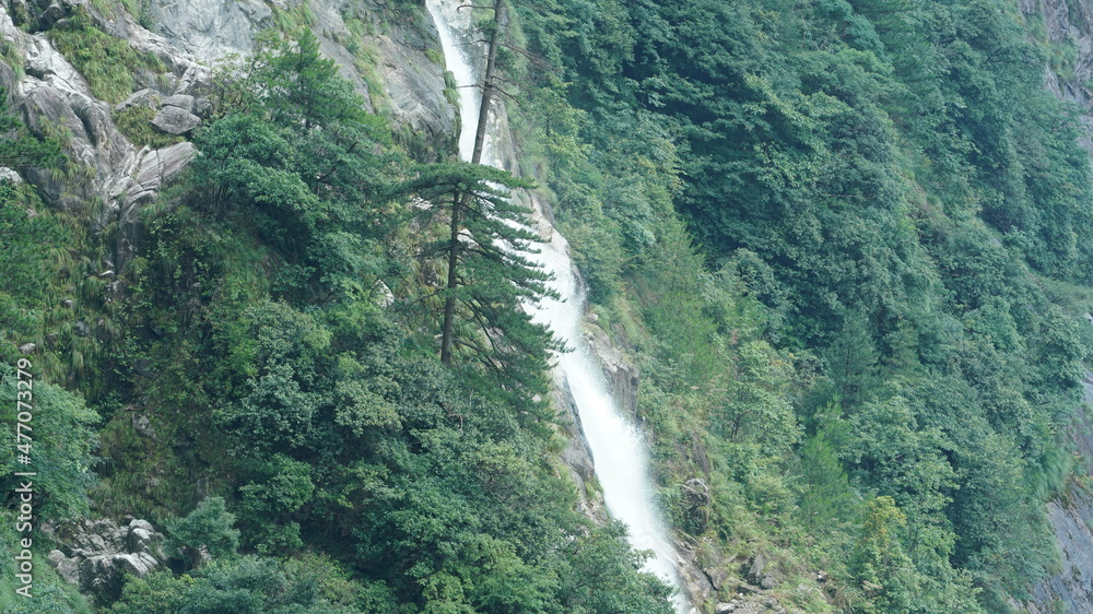 The beautiful countryside view with the waterfall flowing in the mountains after the rainy day The beautiful countryside view with the waterfall flowing in the mountains after the rainy day