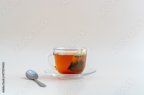 Black tea in transparent cup with tea bag inside