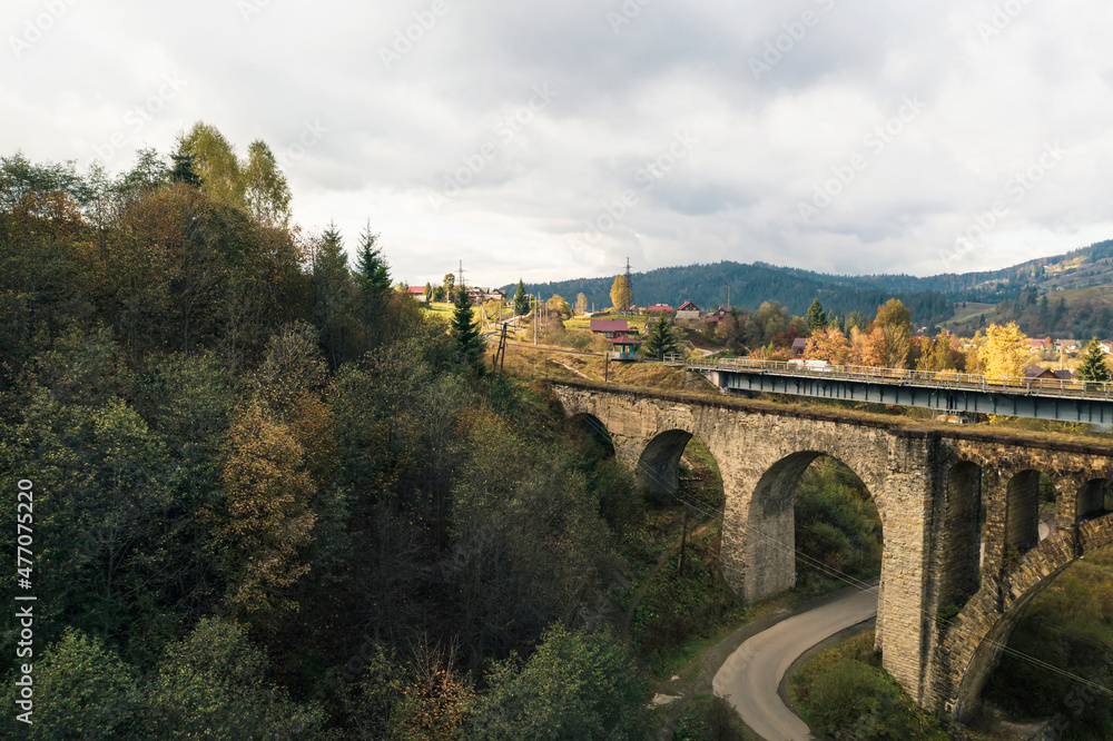 Aerial view of bridge and village on autumn day