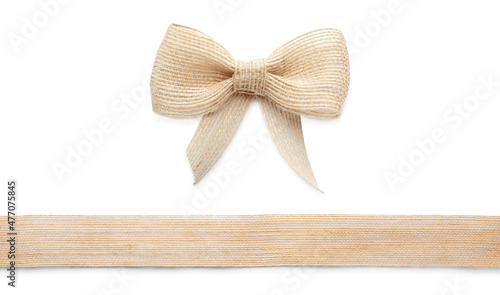 Pretty burlap bow and ribbon on white background photo