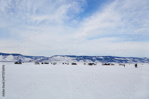 Winter trip on the frozen lake Baikal. A popular holiday destination, many tourists come by car on the ice.