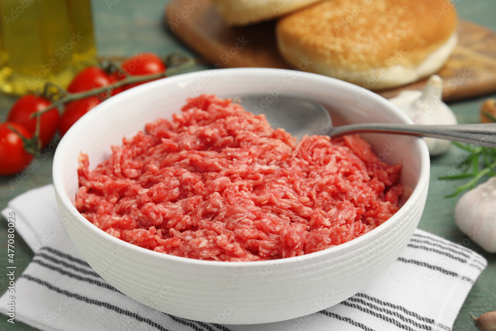 Fresh minced meat in bowl on table, closeup Fresh minced meat in bowl on table, closeup