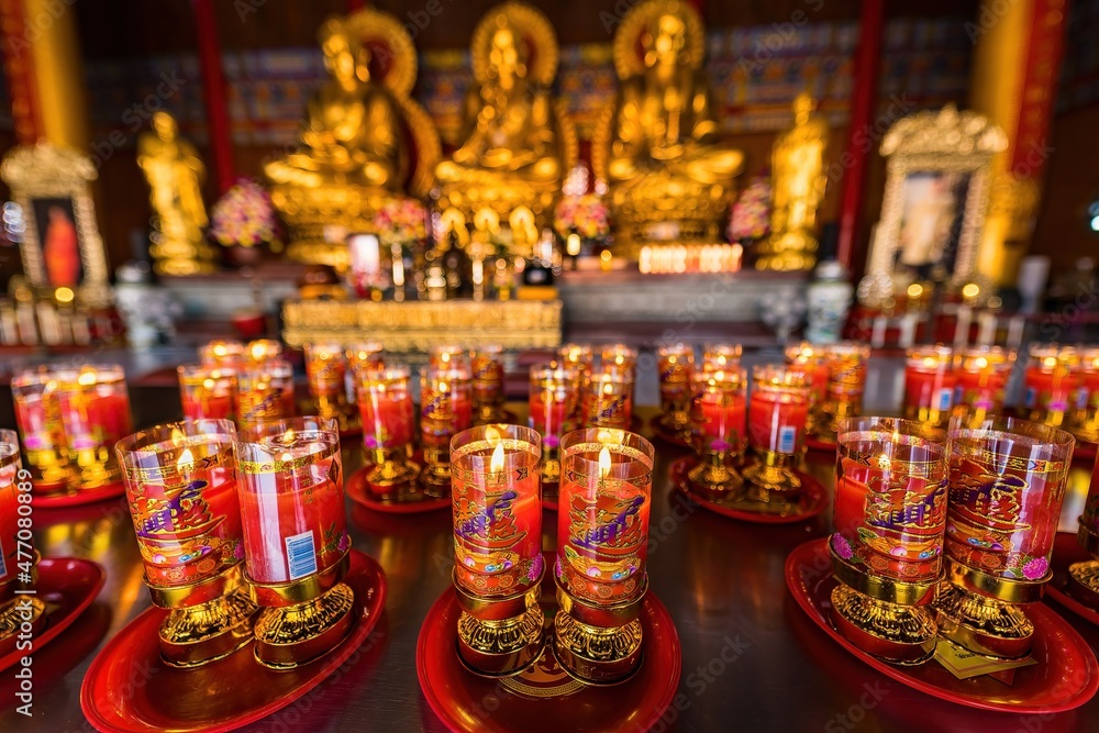 Bangkok, Thailand - December, 20, 2021 : Praying and meditation with burning candle on Chinese temple in Wat Leng Nei Yee 2 Temple at Bangkok, Thailand.