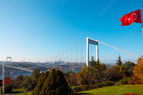 Fatih Sultan Mehmet bridge and Turkish flag in Istanbul. © senerdagasan
