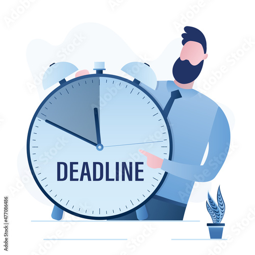 Businessman holding big clock with deadline time. Handsome man points to remaining time to complete work
