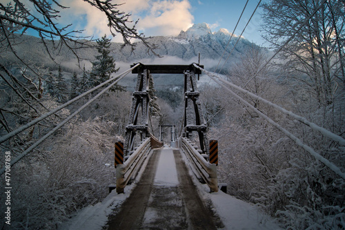 snow covered bridge with mountains