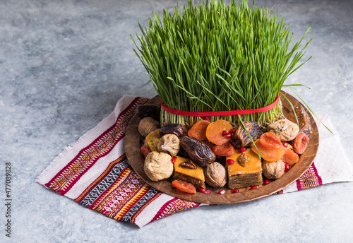 Novruz setting table decoration,  wheat grass, Azerbaijan national pastry pakhlava, new year sring celebration, nature awakening photo