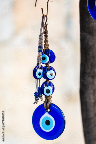 Blue evil eye, nazar boncugu, Turkish symbols hanging on a tree; Cappadocia
